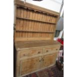 A Victorian pine dresser, the rack with a shaped apron and two shelves,