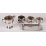 A Russian silver salt, two silver napkin rings, a silver cream jug and a silver pin tray, 5oz.