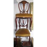 A set of four Edwardian inlaid mahogany side chairs, each with padded seat on cabriole legs,