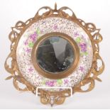 A brass mounted circular Burleigh Ware mirror, diameter 30cm.