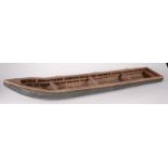 A Japanese wooden model of a sushi boat, inscribed 'F Mao Aquasain', height 13.5cm, width 16.