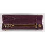 A brass drawing instrument by Elliott, London, in original black leather fitted case,