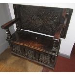 A carved oak monks bench, circa 1920s,