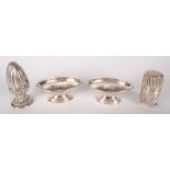 A pair of fluted Victorian silver open salts and two other fluted silver condiments.