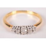 An 18ct gold ring set with five diamonds.