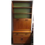 A G Plan teak cabinet, with three shelves and a hinged fall front,