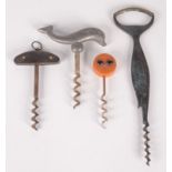 An amber plastic mounted corkscrew, a bone inlaid horn corkscrew and two fish corkscrews.