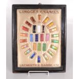 A collection of Limoges enamel samples, on a cream silk panel,