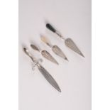 A silver rapier bookmark and three silver bookmarks of trowel shape.