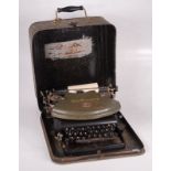 The Empire Lightweight Model green portable typewriter, in original metal case,
