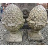 A pair of composition pineapple garden finials, on square plinths, height 54cm, width of base 23.