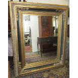 A large gilt and ebonised rectangular wall mirror, 20th century,