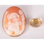 A large cameo brooch and a gold mounted citrine brooch.
