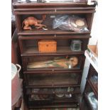 A Globe Wernicke oak five tier bookcase, on a plinth base, each with glazed, lift up door,