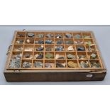 A selection of mineral specimens, in a pine collectors box with two interior trays,