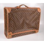 A Louis Vuitton leather and monogrammed suitcase, inscribed in gilt 'RGH', height 41.5cm, width 64.