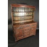 A George III oak dresser, the rack with three shelves,