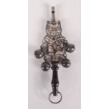 A silver coloured metal cat rattle.
