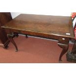 A walnut side table, the top quarter veneered, cross banded and chevron strung on cabriole legs,