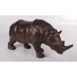 A leather model of a rhinoceros, height 24cm, width 15cm, length 52cm.