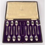 A set of twelve silver Walker & Hall coffee spoons and matching sugar tongs, Sheffield 1915, 5.