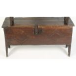 A boarded 17th century chest, the top moulded to the front and notched at the ends,