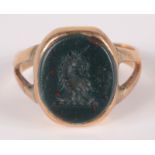 A gold signet ring a with a crested blood stone intaglio.