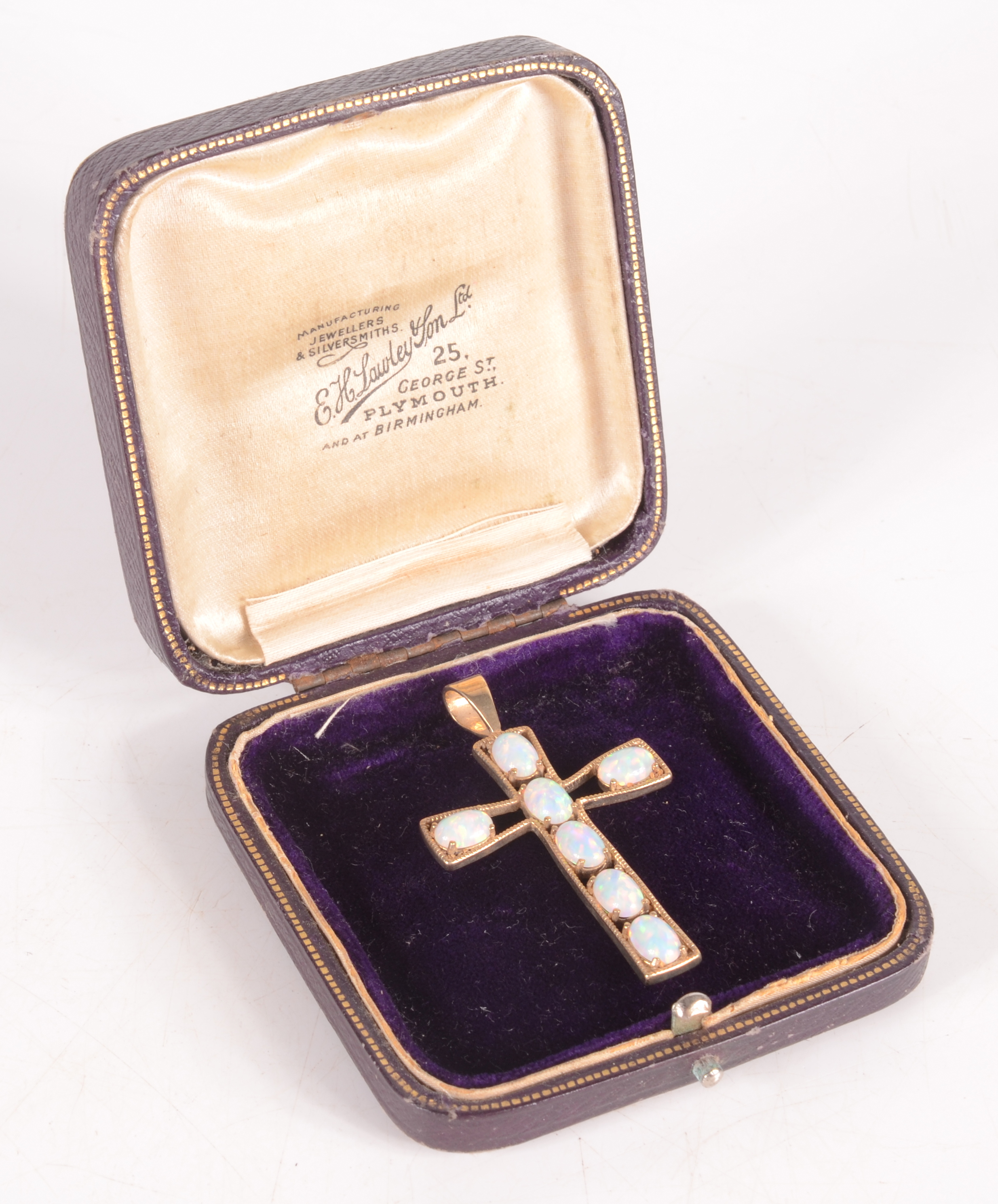 An opal set 9ct gold cross.
