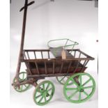 A wooden dog cart, 19th century, with green painted metal seat and wheels, height 59cm, length 88cm,