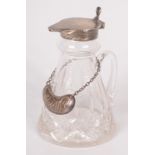 A cut glass individual whisky jug with silver rim and hinged silver lid,