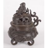 A Chinese bronze censer, 19th century, the pierced cover surmounted by a dog of fo,