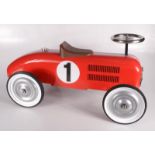 A reproduction red metal child's model of a racing car, height 37cm, width 35.5cm, length 75cm.