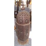 A large metal Moroccan lantern with pierced body and single hinged door, height 100cm, width 29cm.