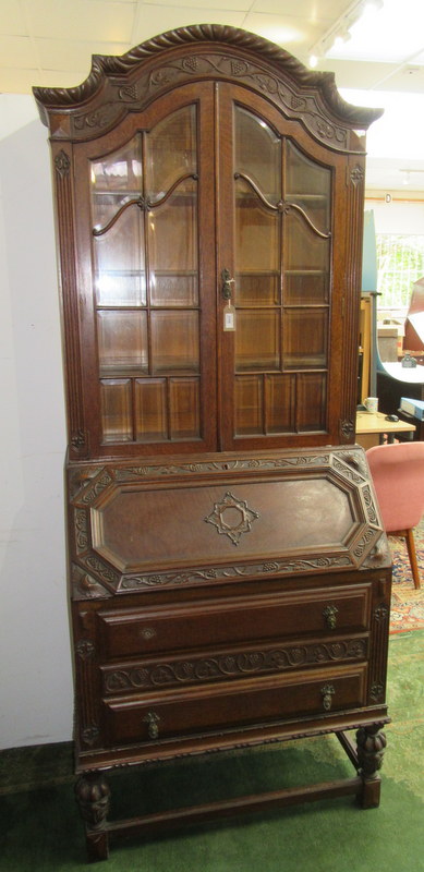 A carved oak secretaire bureau bookcase, early 20th century,
