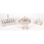 Four silver plated toast racks.