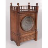 An Arts and Crafts walnut mantel clock, the spindle filled gallery above a 9.