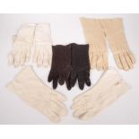Four pairs of ladies kid gloves, two cream, one beige, one brown.