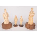 A pair of carved ivory Indian figures, 19th century, on circular wooden plinths, height 12.