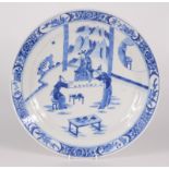 A Chinese blue and white porcelain dish, 18th century, decorated with scribes working on a scroll,