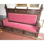 A large continental carved walnut settle, 19th century,