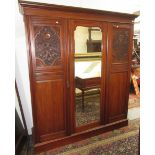 A late Victorian walnut triple wardrobe,