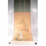 A Japanese scroll painting, early 20th century, with a geisha standing on a bridge before a tree,