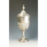 A late Victorian cup and cover with gilt interior repousse acanthus decoration and urn finial,