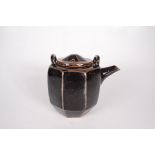A studio pottery tenmoku glaze teapot and cover, with an octagonal tapering body,