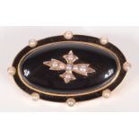 A good Victorian high purity gold mourning brooch, black enamelled and set with pearls,