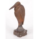 A ceramic model of pelican, on a carved wood base, height 25.5cm.