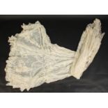 An Edwardian lace tiered underskirt, length 123cm and a lace shawl.