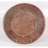 A treen circular bowl, 19th century, height 7cm, diameter 39cm.
