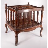 A late Victorian mahogany Canterbury, with three sections, turned spindles on cabriole legs,