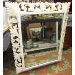A white painted carved wood wall mirror, early 20th century,